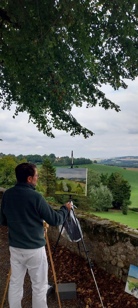 l'artiste Jean-Marc Wettstein en train de peindre un paysage du Gers